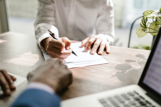 Man signing life insurance contract